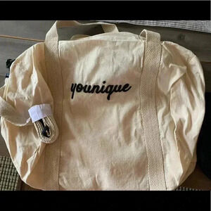 NEW In Box Younique duffle bag with cross body strap cream